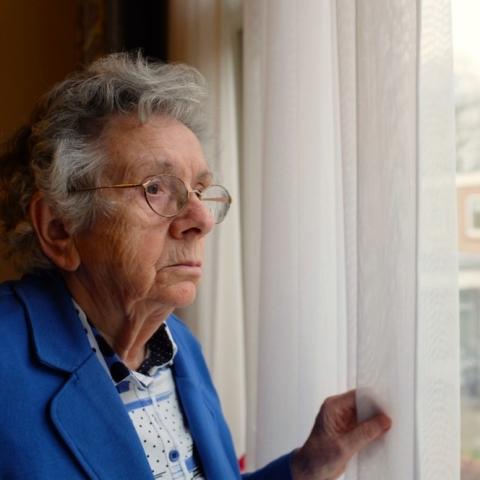 social isolation-older woman looking out of window