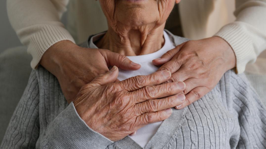 Serious Illness hands over chest