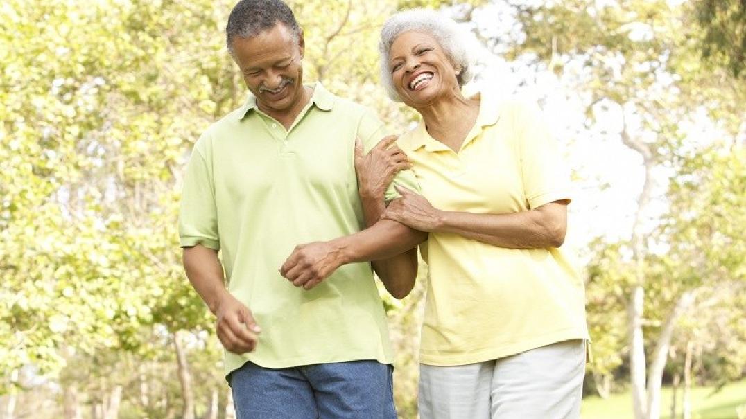 man and woman walking in park - OAA