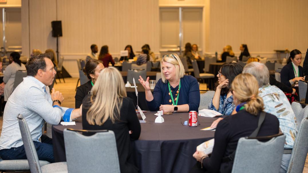 people around a table talking