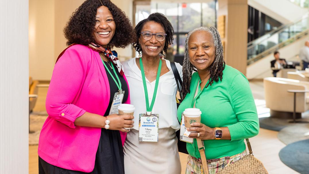 three black women smiling together