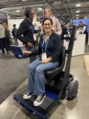 white woman with dark hair in automated wheelchair