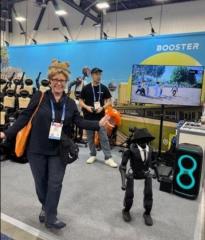 white woman standing next to robot at ces conference