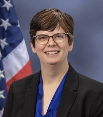 white woman with dark short hair and glasses