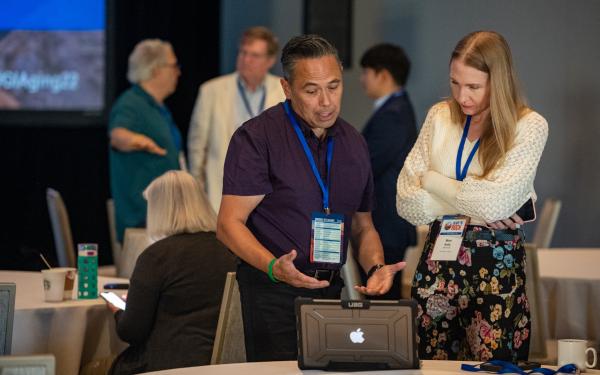 Member demonstrating on laptop at 2022 Conference