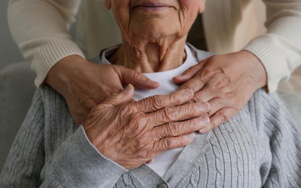 Serious Illness hands over chest