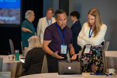 Member demonstrating on laptop at 2022 Conference